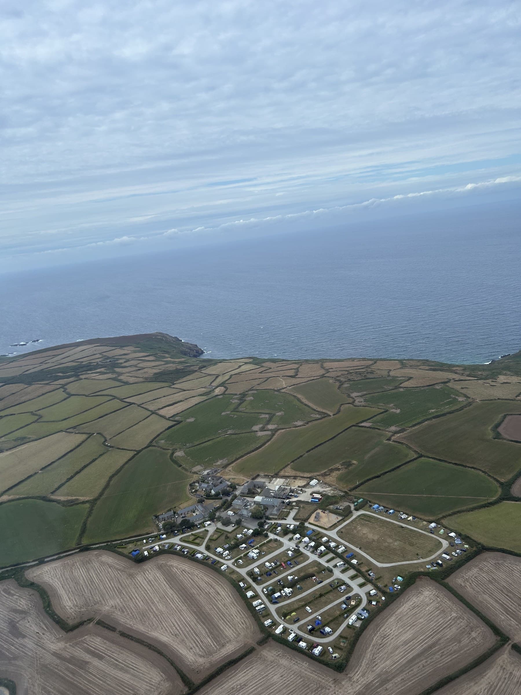 The Cornish coastline seen from the air during the helicopter flight, fields meeting the sea